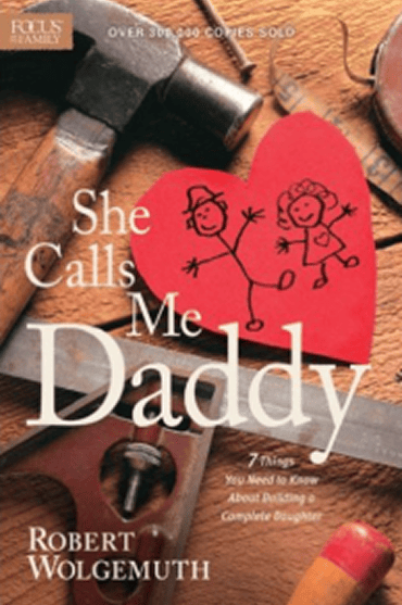 Book cover for 'She Calls Me Daddy' by Robert Wolgemuth with children's drawings and tools.