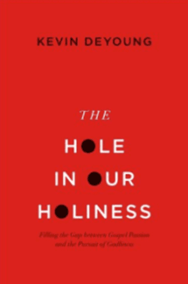 Book cover of 'The Hole in Our Holiness' by Kevin DeYoung with red background.
