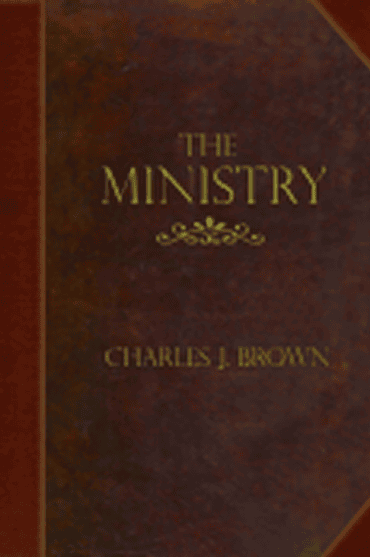 Close-up of 'The Ministry' book cover by Charles J. Brown with gold lettering.
