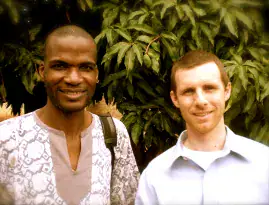 Two men smiling outdoors, representing cultural diversity at Trinity Baptist Church.