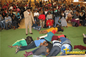 Congregation praying and worshiping during a church service.