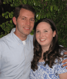 Happy couple in South Africa with lush green background.