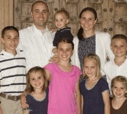 Happy family portrait with children and parents in Tanzania setting.