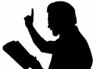 Silhouette of preacher reading and gesturing passionately during sermon.