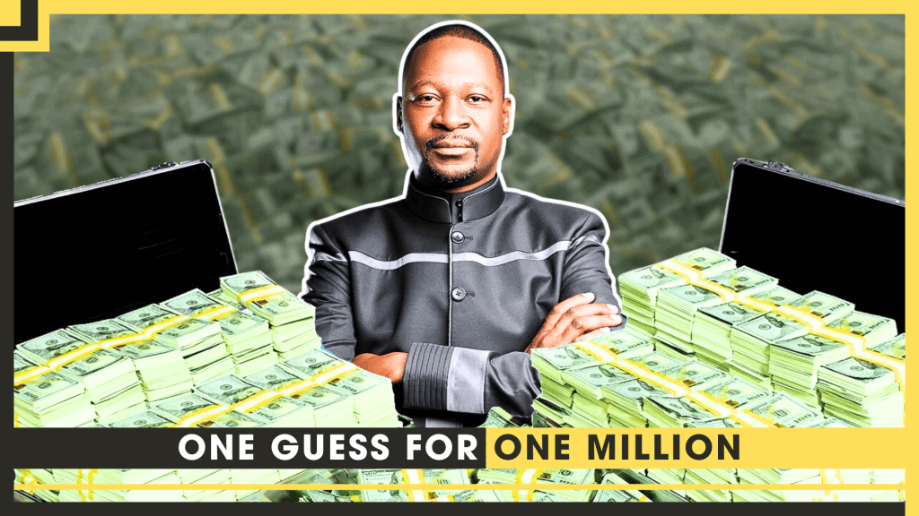 Man in black suit with arms crossed, surrounded by stacks of money and laptops.