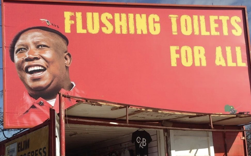 Sign for flushing toilets available for all in South Africa.