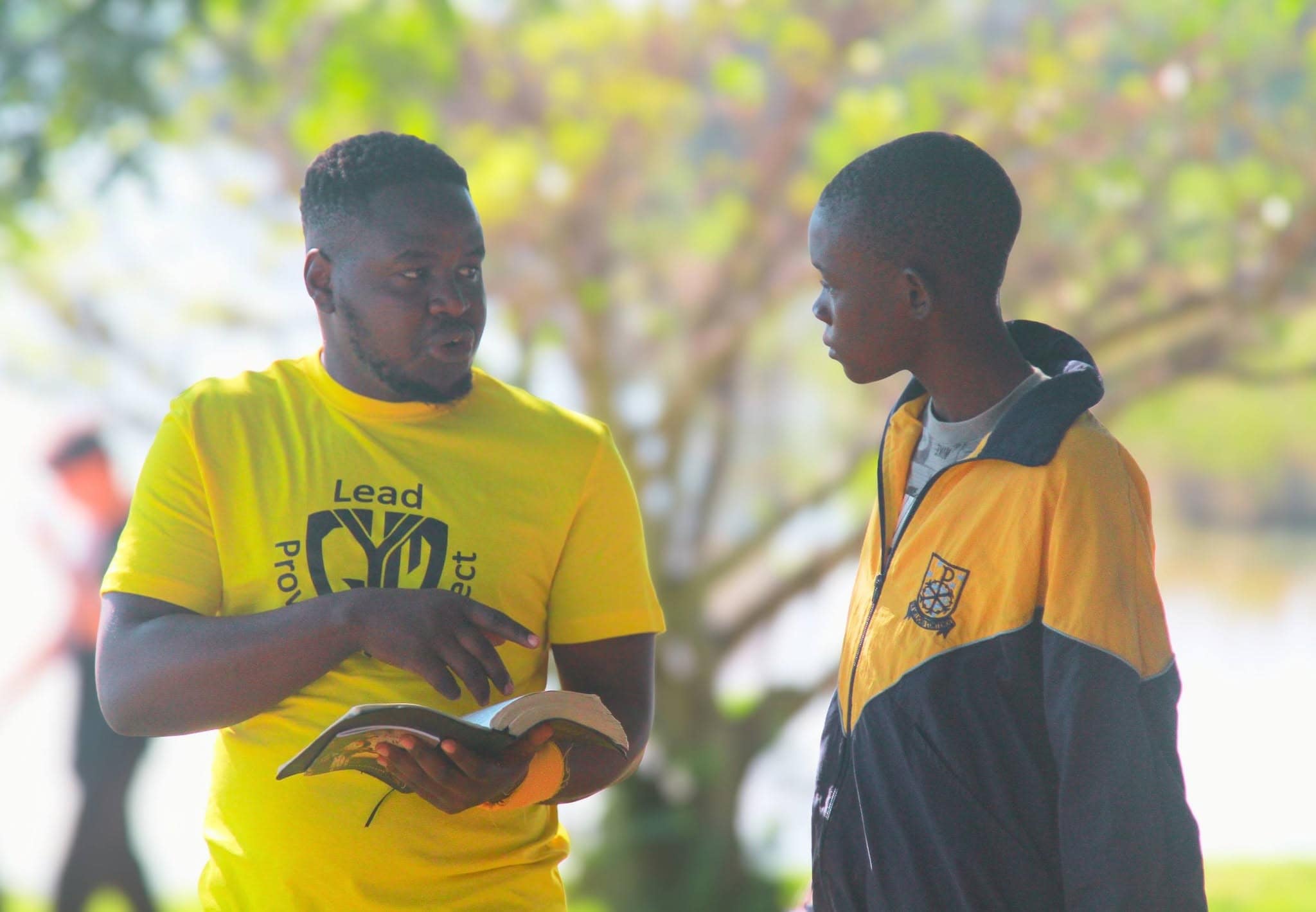 Lead Project mentor sharing from the Bible with a young man during a Christian youth mentoring session.