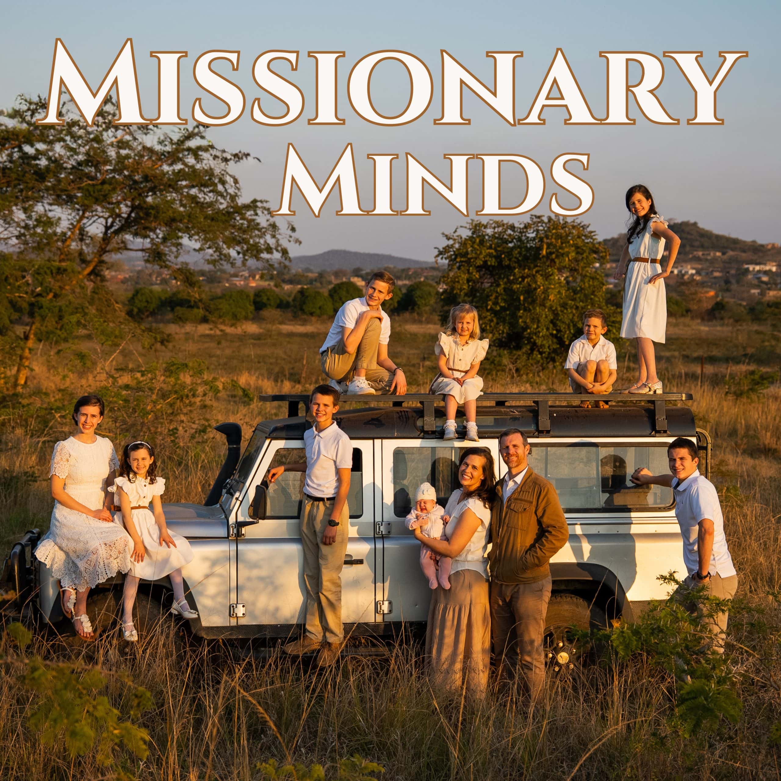 Missionary Minds family posing beside and on a safari vehicle in an African landscape at sunset.
